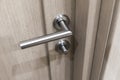 Detail of wooden door. Door handle close-up with blurred background. Royalty Free Stock Photo