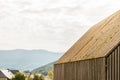 Detail of wooden slat facade and gable roof with moss texture Royalty Free Stock Photo