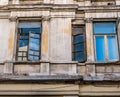 Detail of an worn out old building with windows in the center of Bucharest Royalty Free Stock Photo