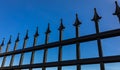 Detail of wrought iron fence. Decorative Steel Gate against blue sky Royalty Free Stock Photo