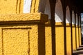 Detail of yellow arches of an old Portuguese era building Royalty Free Stock Photo