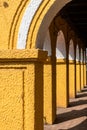 Detail of yellow arches of an old Portuguese era building Royalty Free Stock Photo