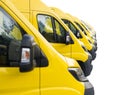 Detail on yellow vans lined up and parked in a long row isolated on white background. Delivery trucks fleet Royalty Free Stock Photo