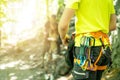 Detail of young man who preparing on a climb and standing a next to rock wall. Equipment for climbing on a man with copy space for Royalty Free Stock Photo