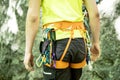 Detail of young man who preparing on a climb and standing a next to rock wall. Equipment for climbing on a man with copy space for Royalty Free Stock Photo