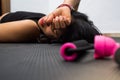 Detail of young woman exhausted after doing exercise at home with jump rope. Female athlete taking rest after fitness training at Royalty Free Stock Photo