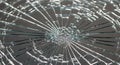 Close-up of shattered glass with radial cracks on a dark background Royalty Free Stock Photo
