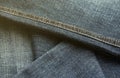 Detailed abstract texture of dark blue denim cloth. Background image of old used denim trousers fabric Royalty Free Stock Photo