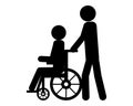 Person pushes wheel chair user Royalty Free Stock Photo