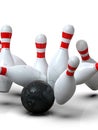 Bowling ball hitting all pins scoring strike, action shot, white background Royalty Free Stock Photo