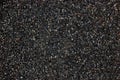 Asphalt texture pattern, large detailed dark textured tarmac closeup, horizontal copy space background, black grey colorful gravel