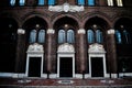 A Detailed Brick Building With Three Large Black Doors