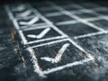 Detailed chalk-drawn checklist with multiple check marks on a dark textured surface highlighting progress and completion of tasks Royalty Free Stock Photo