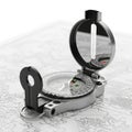 Silver Compass with Open Lid Resting on a Detailed Map in Black and White navigation Royalty Free Stock Photo