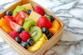 A detailed close up of a bowl filled with various fruits placed on a wooden table, A colorful fruit salad contained in a bamboo Royalty Free Stock Photo