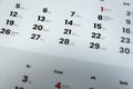 A detailed close-up of a calendar page displaying various dates and names in a structured layout. Useful for planning, s Royalty Free Stock Photo