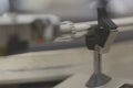 Close-Up of a Vintage 1980s Turntable Tonearm Rest with Secure Locking Mechanism