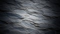 Detailed close up of dark grey slate rock surface with layered texture and subtle light and shadow variations Royalty Free Stock Photo