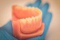 Detailed close up of dental denture or teeth presented on a blue