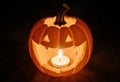 Detailed Close-Up of a Jack-o\'-Lantern with a Burning Candle Inside, Casting a Warm Light and Emphasizing Texture Royalty Free Stock Photo