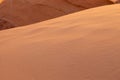 A detailed close-up an orange sand dune in ambient light Royalty Free Stock Photo