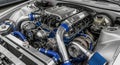 Detailed view of a powerful custom car engine with chrome and blue accents V8 engine automotive Royalty Free Stock Photo