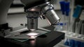 Modern Microscope with Illuminated Sample in a Laboratory Setting Royalty Free Stock Photo