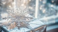 detailed close-up of a sparkling snowflake ornament on a gift wrapped in metallic silver paper