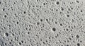 Close-up Macro Texture of a Light Gray Porous Surface with Numerous Small Pits and Cracks background Royalty Free Stock Photo
