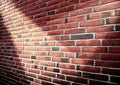 Detailed close up view at a red brick wall with multiple spotlights on it