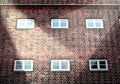 Detailed close up view at a red brick wall with multiple spotlights on it