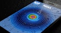 Close up smartphone screen with colorful concentric circles pattern and water droplets on blue background with NOAA text visible Royalty Free Stock Photo