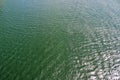 Detailed close up view on water surfaces with reflecting sunlight on the waves and ripples Royalty Free Stock Photo