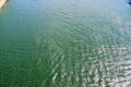 Detailed close up view on water surfaces with reflecting sunlight on the waves and ripples Royalty Free Stock Photo