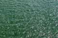 Detailed close up view on water surfaces with reflecting sunlight on the waves and ripples Royalty Free Stock Photo