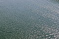 Detailed close up view on water surfaces with reflecting sunlight on the waves and ripples Royalty Free Stock Photo