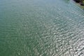 Detailed close up view on water surfaces with reflecting sunlight on the waves and ripples Royalty Free Stock Photo