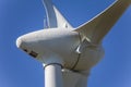 Detailed close up view of a wind turbines; generator, rotor and blade view on blue sky background