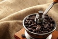 Caffeine rich strong stimulant beverage conceptual idea with detailed close up vintage manual coffee grinder with beans full of Royalty Free Stock Photo