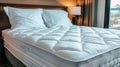 Detailed close up of a white mattress protector on a bed for enhanced search relevance