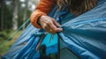 Detailed close up of young woman s hands unzipping tent flap in a precise and focused view