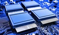 A detailed closeup of four computer chips on a dark blue circuit board showing complexity Royalty Free Stock Photo