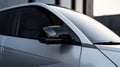 A detailed closeup of the side mirrors base showcases its slim design minimizing bulk and maximizing the cars striking