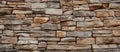 Closeup of a brown stone wall with a lot of rectangular bricks and mortar Royalty Free Stock Photo