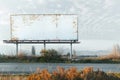 Blank, Rusty Billboard with Copy Space Next to an Empty Road in the Countryside Royalty Free Stock Photo