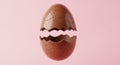 Broken Chocolate Easter Egg on Pink Background Royalty Free Stock Photo