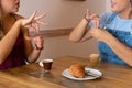 Detailed drawing of two young women drinking coffee and speaking in sign language Royalty Free Stock Photo