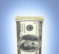 Detailed fluffy stack of money american hundred dollar bills isolated on blue gradient background 3d