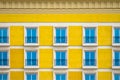 Detailed front view of a facade with windows with balconies and yellow wall