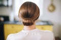 detailed golden hairpin adorning a sleek low chignon